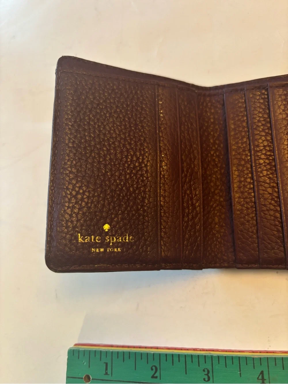 kate spade plum pebbled leather trifold wallet with gold logo